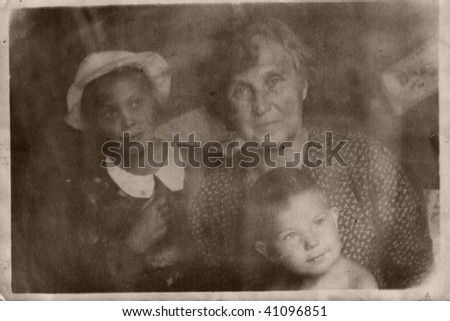 Family. Vintage portrait. Grandmother and grandchildren, middle XX century