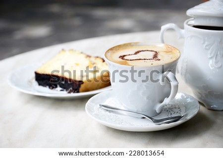 Cup of coffee and cake in cafe