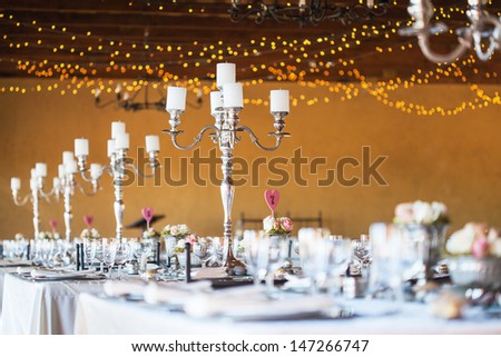 Wedding Reception Hall With Decor Including Candles, Cutlery And Crockery; Selective Focus On Candelabra