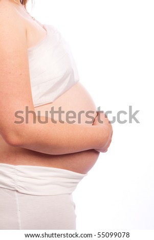Young Caucasian pregnant woman in white clothes lovingly holding her tummy. Isolated on white