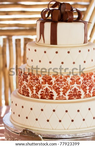 stock photo Layered white wedding cake with chocolate detail on silver 