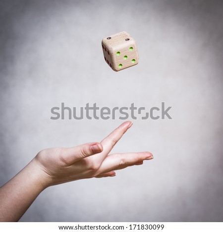 Dice made from wood throw on the gray background