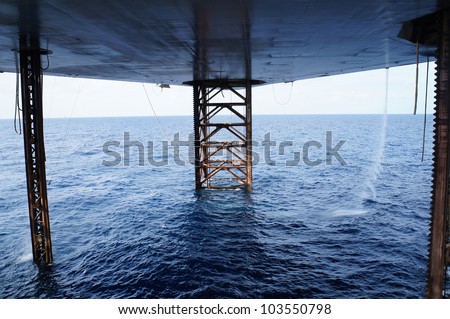 Underneath Jack Up Drilling Rig In The Ocean - Oil and Gas Industry