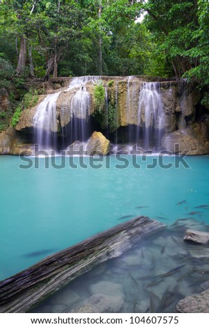 Deep forest waterfall (Erawan Waterfall) in Thailand and Fish in The Waterfall Lake
