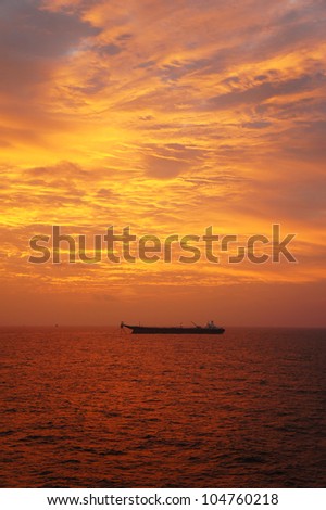 Offshore Oil Production Tanker in The Middle of The Ocean at Sunset Time