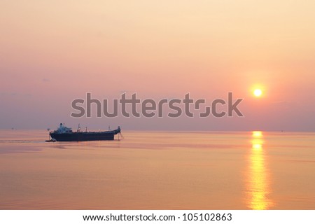 Offshore Oil Tanker and Small Crew Boat in The Offshore Oil and Gas Production Field at Sunset Time