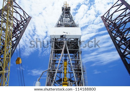 Front View of Derrick of Offshore Oil Drilling Rig and Rig Legs on Sunny Day