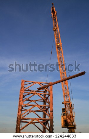 Rig Crane Lifts A Bundle of Drill Pipe To The Drilling Jack Up Rig