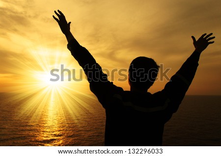 Silhouette Image of Man Raising His Hands With Ray of Light