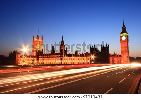Big Ben with long light beam at twilight time, London, UK