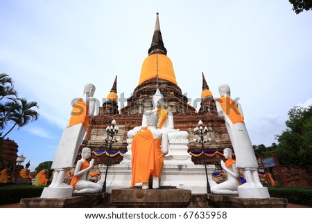 White Buddha images in front of ancient pagoda in Ayuthaya, Thailand