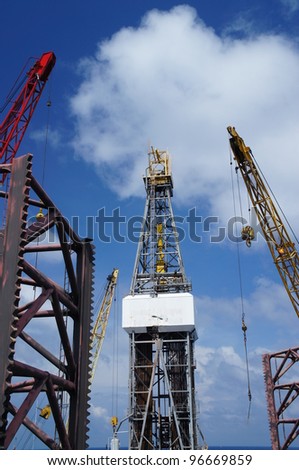 Offshore Drilling Rig (Jack Up Rig) With Rig Cranes on Sunny Day - The View From The Bow Leg of The Rig