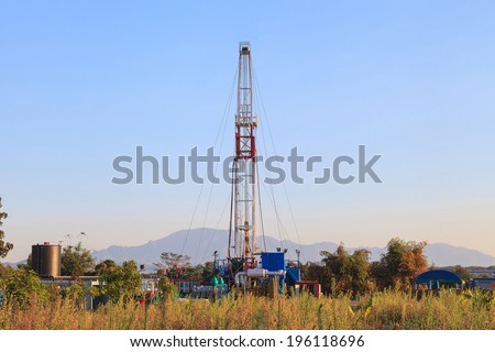 Oil Land Drilling Rig Working In The Field For Petroleum Exporation at Sunset Time