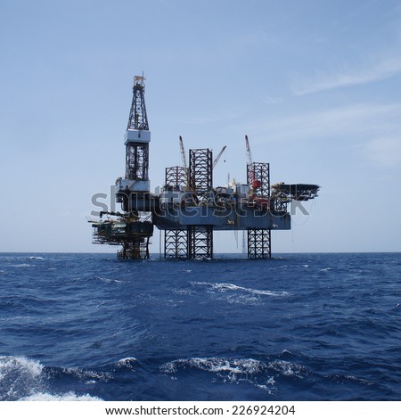Offshore Jack Up Oil Drilling Rig and The Production Platform in The Middle of The Ocean Working For Petroleum Development Project