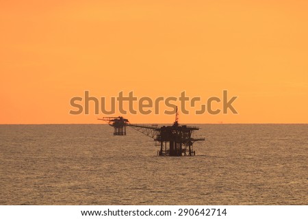 Offshore platform in the middle of the ocean with beautiful sunset