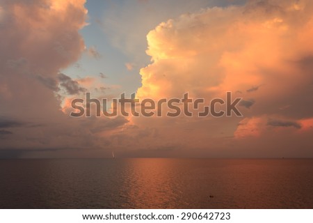 Beautiful sun rise and dramatic sky with lighting to the small platform in the middle of the ocean
