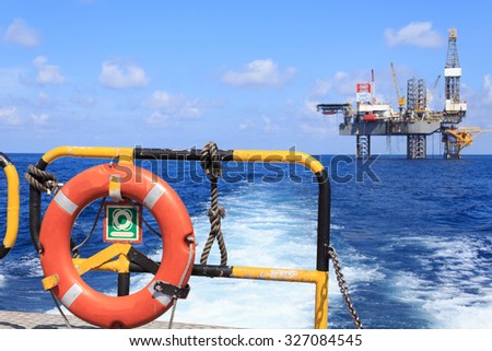 life ring on the offshore supply boat with Jack up drilling rig background