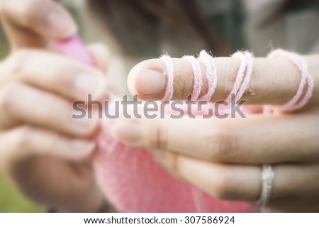 woman with her crochet focus to point finger