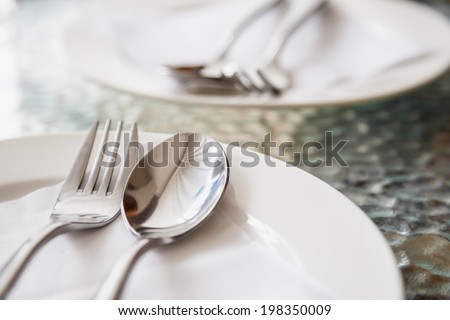 Couple empty disk with spoon and fork on dating seat at the restaurant