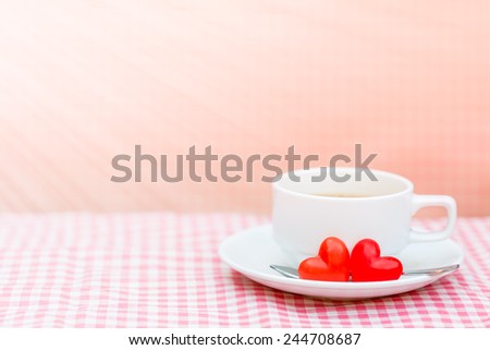Red Heart chocolate  and coffee white cup on pink plaid for Valentine background