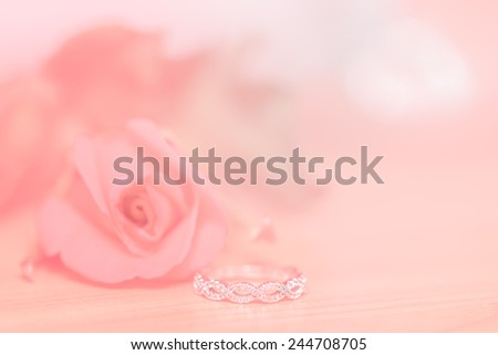 wedding ring and red rose on wood blur and bokeh  for valentine background