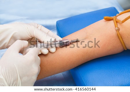 Nurse pricking needle syringe to collect blood for test the health Close up shot