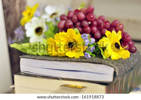 Books and flowers in a vase stock image