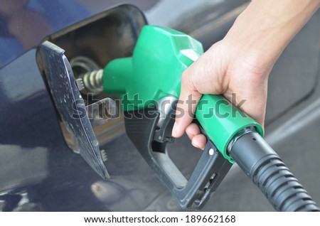 focus  at hand refilling the car with fuel on a filling station