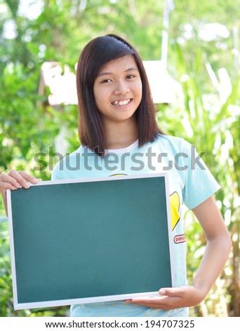 Woman showing sign. Cute casual young beautiful woman showing blank  green sign