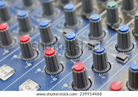 Control buttons for electronic sound. A sliders of a mixing console. Audio signals modifications to achieve the desired output. Applied in recording studios, broadcasting, TV and film production