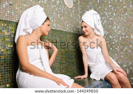 Two beautiful girls talking in Turkish sauna