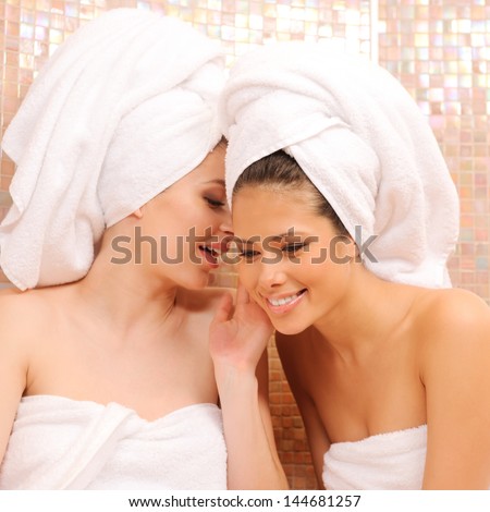 Two young girls gossiping in Turkish sauna