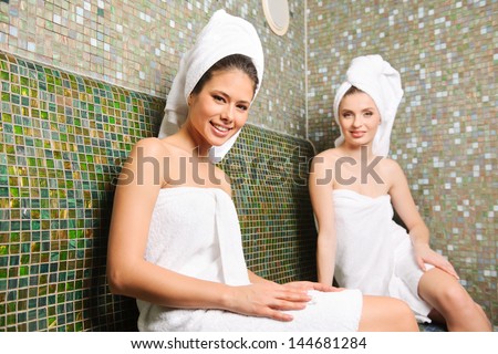 Two young beautiful girls having relax in Turkish sauna