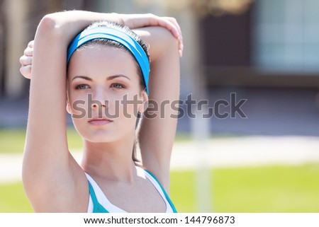 Doing her exercises. Portrait of beautiful young woman doing her outdoor exercises