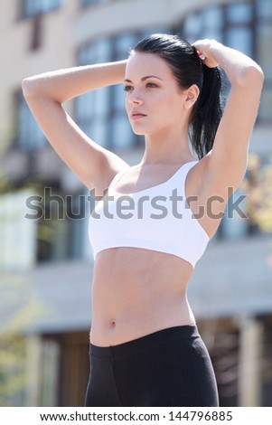 Woman doing exercises. Beautiful woman doing her outdoor exercises