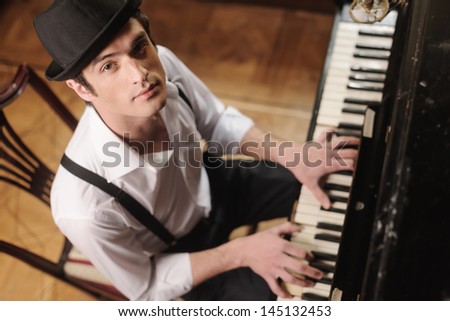 Expressing Myself With Music. Top View Of Handsome Young Men Playing Piano And Looking At Camera