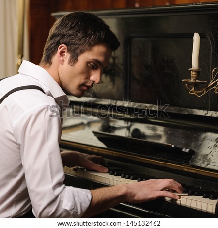Making Music. Profile Of A Handsome Young Men Playing Piano