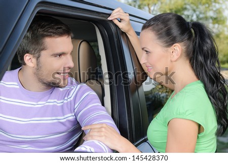 Attractive young woman holding the hand of her boyfriend ready to go on the car