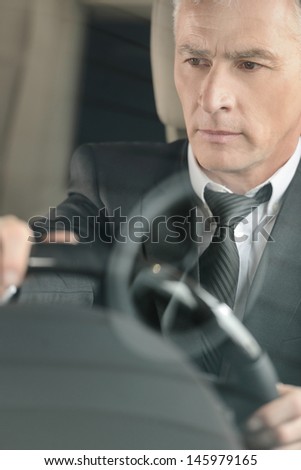 Senior businessmen driving a car. Confident senior businessman driving a car