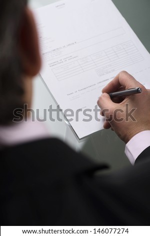Signing an agreement. Top view of businessman signing a contract