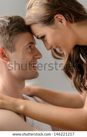 Romantic mood. Close up of beautiful young couple looking at each other and smiling