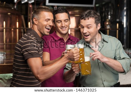 Old Friends. Three Happy Friends Drinking Beer At The Pub