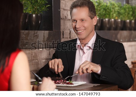 Night out at the restaurant. Mature couple having dinner at the restaurant