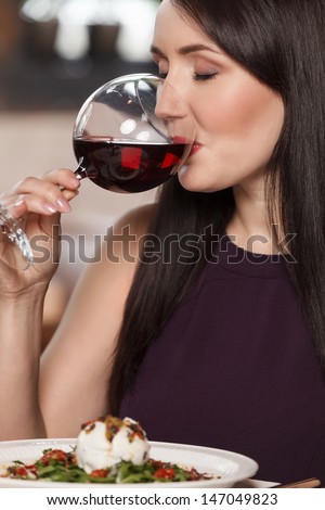 Good wine. Portrait of beautiful mature women drinking wine in restaurant