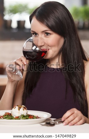 Women drinking wine. Beautiful mature women drinking wine in restaurant