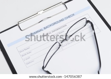 Criminal Background Check Document. Close-Up Of Criminal Background Check Document With A Eyeglasses Lying On It