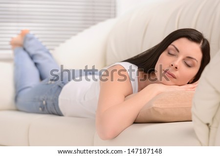 Tired women. Beautiful middle-aged women sleeping on the sofa
