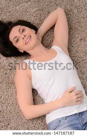 Women on the floor. Top view of cheerful middle-aged women lying on the floor and smiling