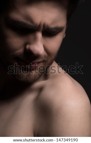 Disappointed men. Portrait of men with naked torso expressing negativity while isolated on black