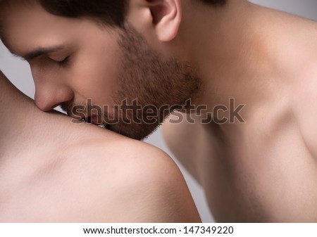 Kissing her shoulder. Close-up of handsome young men kissing his girlfriendÃ?Â¯Ã?Â¿Ã?Â½ shoulder